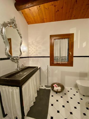 a bathroom with a sink and a mirror at Casa delle Fate - between Nature and Harmony in Boccon