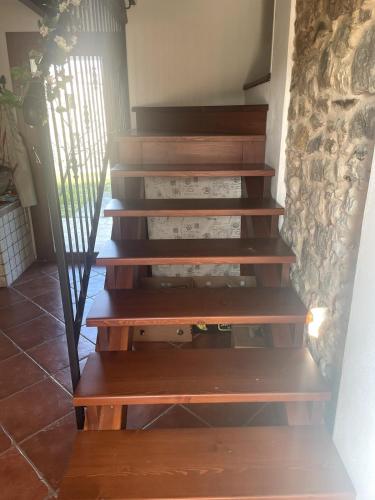 a set of wooden stairs in a room at Casa delle Fate - between Nature and Harmony in Boccon