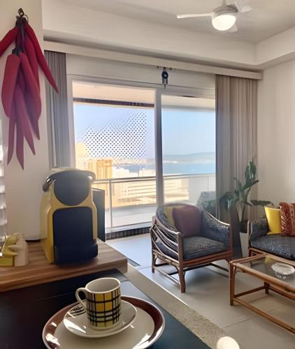 a living room with a view of the ocean at Brisa à Beira-Mar: Desfrute do melhor no Gonzaga in Santos