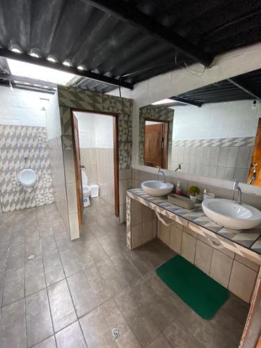 a bathroom with two sinks and a large mirror at Finca Castillo de Altura in San Juan