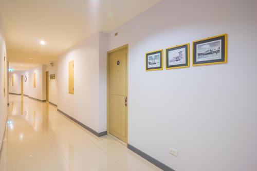 a hallway of a hospital with two pictures on the wall at Vapa Hotel - SHA Extra Plus in Phuket Town