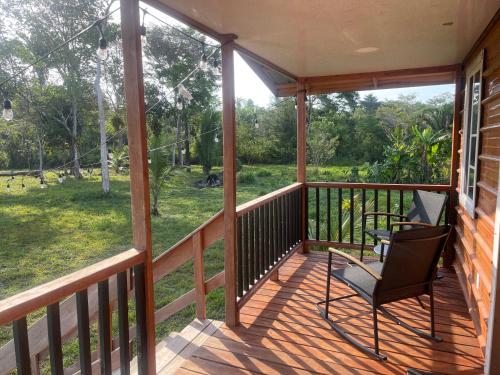 a screened in porch with a chair on it at Palms & Paradise in Machaca Camp