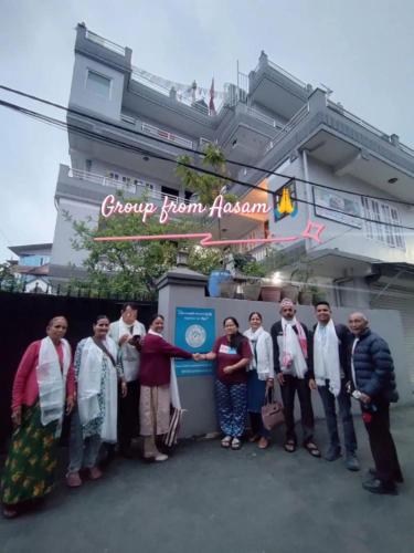 a group of people standing in front of a building at Friendship Home Stay in Kathmandu