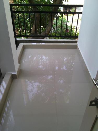 a view from the inside of a room with a balcony at Nathans Holiday Home in Cochin