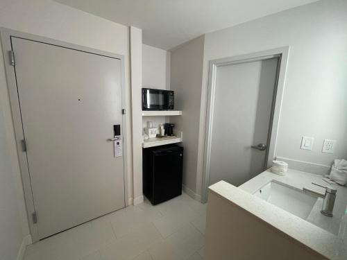a bathroom with a sink and a microwave at Comfort Inn & Suites Salt Lake City I-80 I-15 Downtown in Salt Lake City