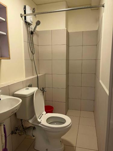a small bathroom with a toilet and a sink at URBAN DECA Homes SM EAST Pasig in Manila