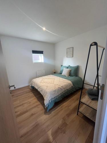 a bedroom with a bed and a ladder in it at Les gîtes de l'ancienne ferme in Penly