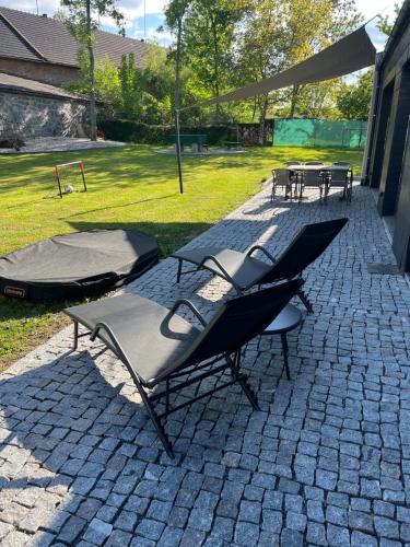 a group of tables and chairs on a patio at Domek Prosetin244 in Prosetín