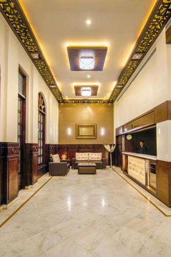 a lobby of a building with couches and a lobby at Hotel Abhinandan in Mathura