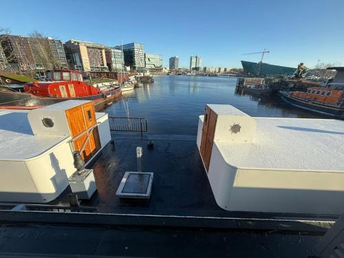 a group of boats are docked in a harbor at Houseboat-Amsterdam-Classic in Amsterdam