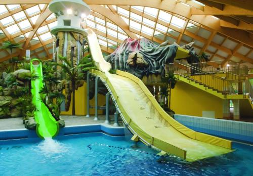 a slide in a swimming pool with a water park at Spa Cottage the Moon house Terme Čatež in Čatež ob Savi