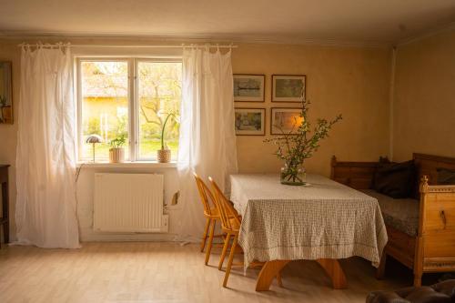 a dining room with a table and a window at Countryside house with sauna in Enhörna
