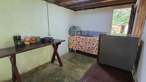 a kitchen with a table and a refrigerator in a room at Manglenato in El Valle
