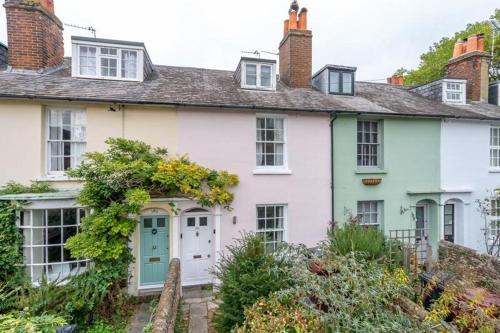 a white house with a blue door at Charming Cottage mins from Chichester City Centre in Chichester