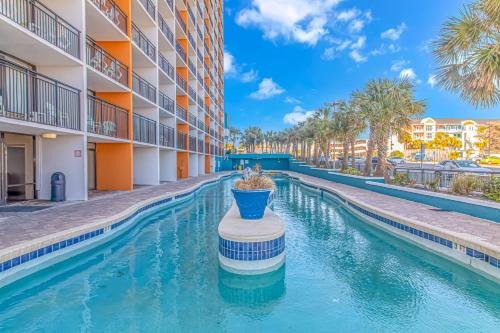 a swimming pool in the courtyard of a apartment building at Modern & Updated Oceanview Studio! Sleeps 4! Landmark 523 in Myrtle Beach