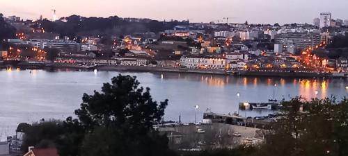 a view of a city with a river at night at Casa MIRA DOURO in Vila Nova de Gaia