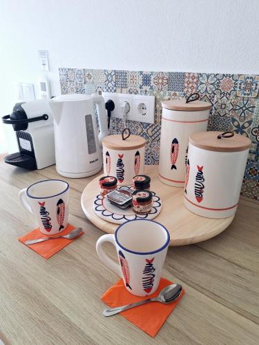 a group of coffee cups sitting on top of a counter at Romantik Villa in Salema