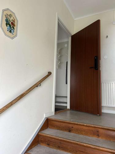 a hallway with a wooden door and stairs at Newly refurbished Apartment in Västervik