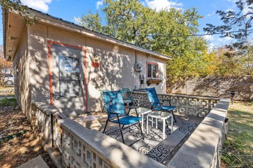 a porch with two blue chairs and a table at Villa 101, Scenic river view from patio in Glen Rose
