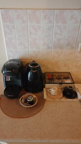 a table with a coffee maker and a tea pot and tray at Guesthouse Kallisti in Anilio Pelion