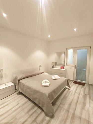 a bedroom with a bed with two towels on it at Il Sogno di Francesca in Alghero