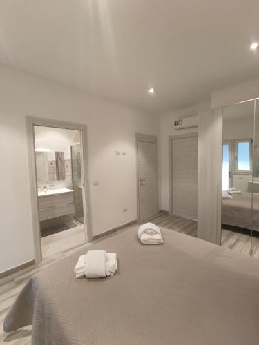 a bedroom with a bed with two towels on it at Il Sogno di Francesca in Alghero