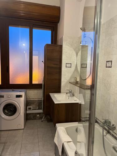 a bathroom with a sink and a washing machine at Apartment 11 in Villa San Giovanni