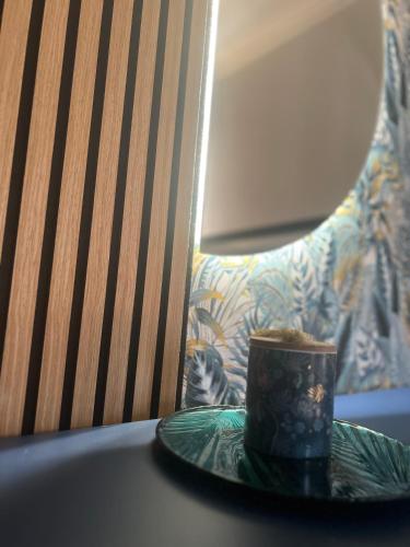 a candle on a plate on a table with a chair at Apartment 11 in Villa San Giovanni