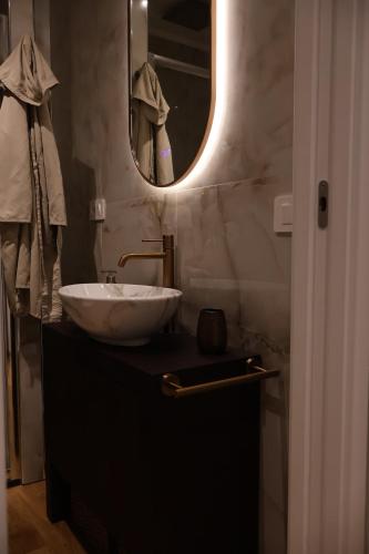a bathroom with a sink and a mirror at Casa di Giò in Todi