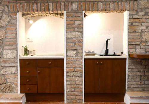 a bathroom with two mirrors and a sink at Casa di Giò in Todi