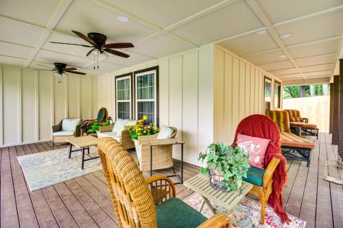 a screened in porch with chairs and a ceiling fan at Historic Dahlonega Home with Hot Tub and Porch! in Dahlonega