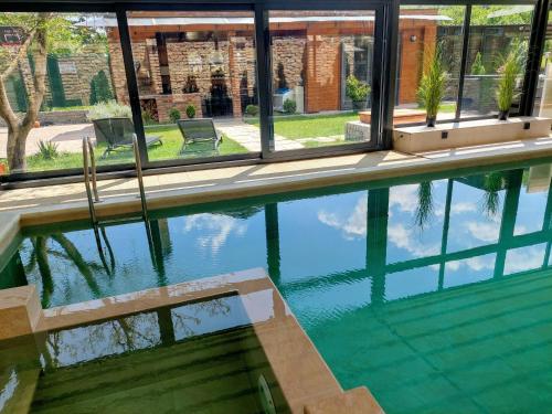 a swimming pool with a view of a house at Vila MP Banstol 4*- Brdež do, Fruška gora in Inđija