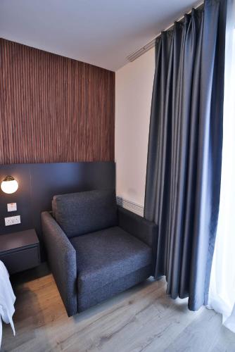 a chair sitting in a room next to a window at Finsbury Rose in London