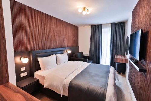 a hotel room with a bed and a television at Finsbury Rose in London