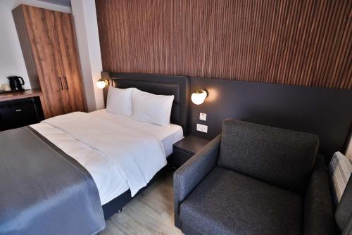 a hotel room with a bed and a chair at Finsbury Rose in London
