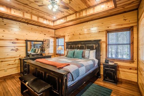 a bedroom with a bed in a wooden cabin at Time Well Wasted in Stephens Gap