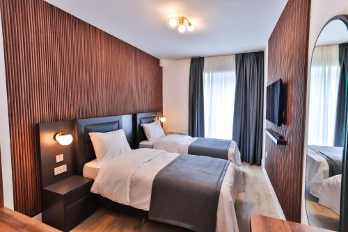 a hotel room with two beds and a television at Finsbury Rose in London