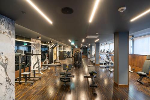 a gym with dumbbells and chairs in a room at InterContinental Athenee Palace Bucharest by IHG in Bucharest