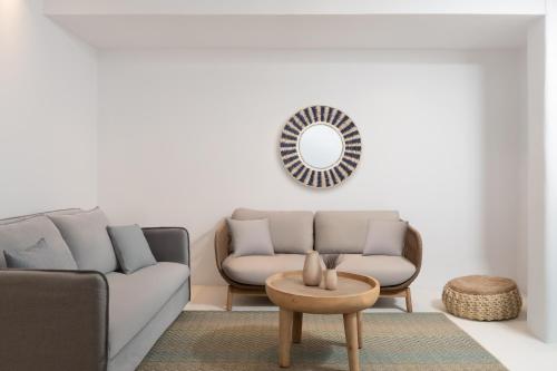 a living room with a couch and a table at Frati Villas Beachfront in Perivolos