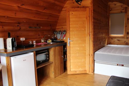 a kitchen in a log cabin with a sink and a refrigerator at Quinta da Devesa -B2 in Vinhais