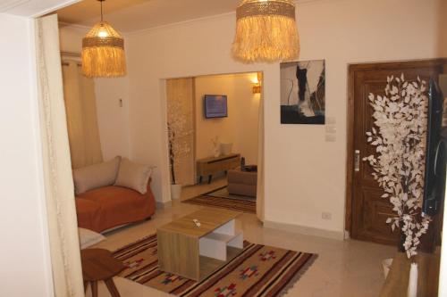 a living room with a couch and a table at The Happy Home in Banī Ghālib