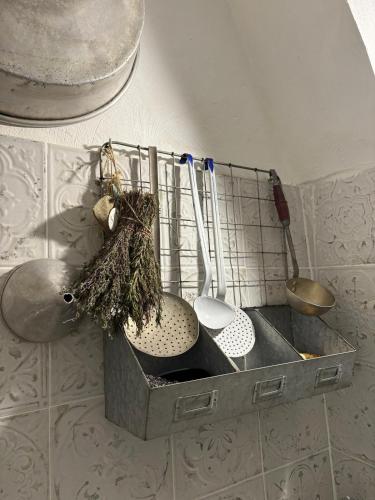 un évier de cuisine avec trois ustensiles dedans dans l'établissement Maison de village avec vue magnifique, à Cagnes-sur-Mer