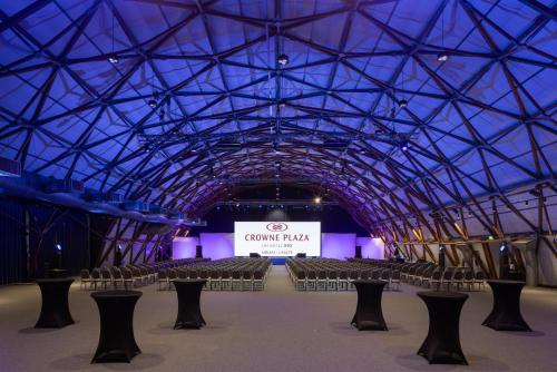 a large room with rows of chairs and a sign at Crowne Plaza Milan Linate by IHG in San Donato Milanese