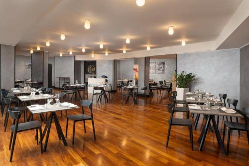 a restaurant with wooden floors and tables and chairs at Crowne Plaza Milan Linate by IHG in San Donato Milanese