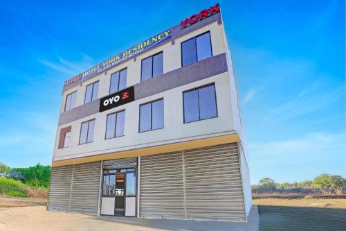 a hotel building with a large garage at Super Hotel O York Residency in Bhopal