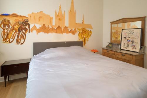 a bedroom with a large white bed in a room at In De Wulf in Ypres