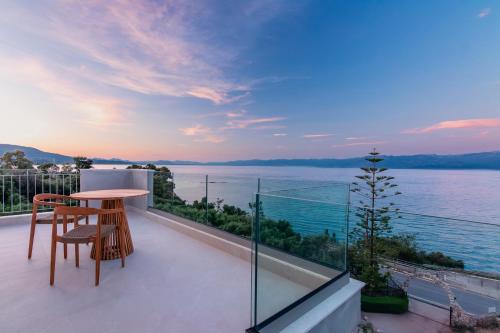 a balcony with a table and a view of the water at Pelagia Apartments in Koroni