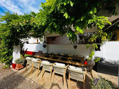 a patio with chairs and a table and a grill at Villa DEA - Home away from home - Families Only in Salou