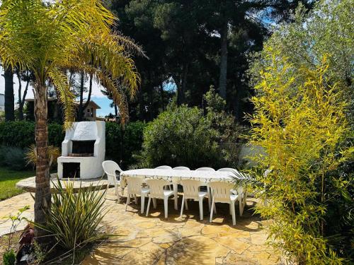 a group of tables and chairs in a garden at Villa DEA - Home away from home - Families Only in Salou