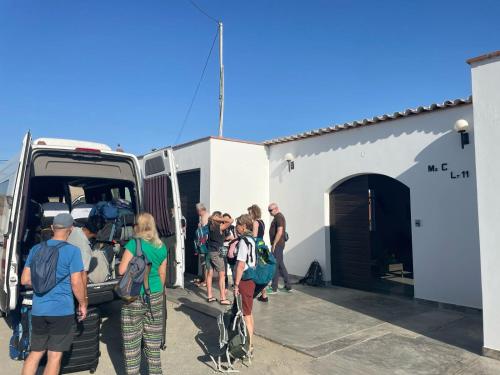 a group of people getting off of a van at Huacachina Desert House in Ica